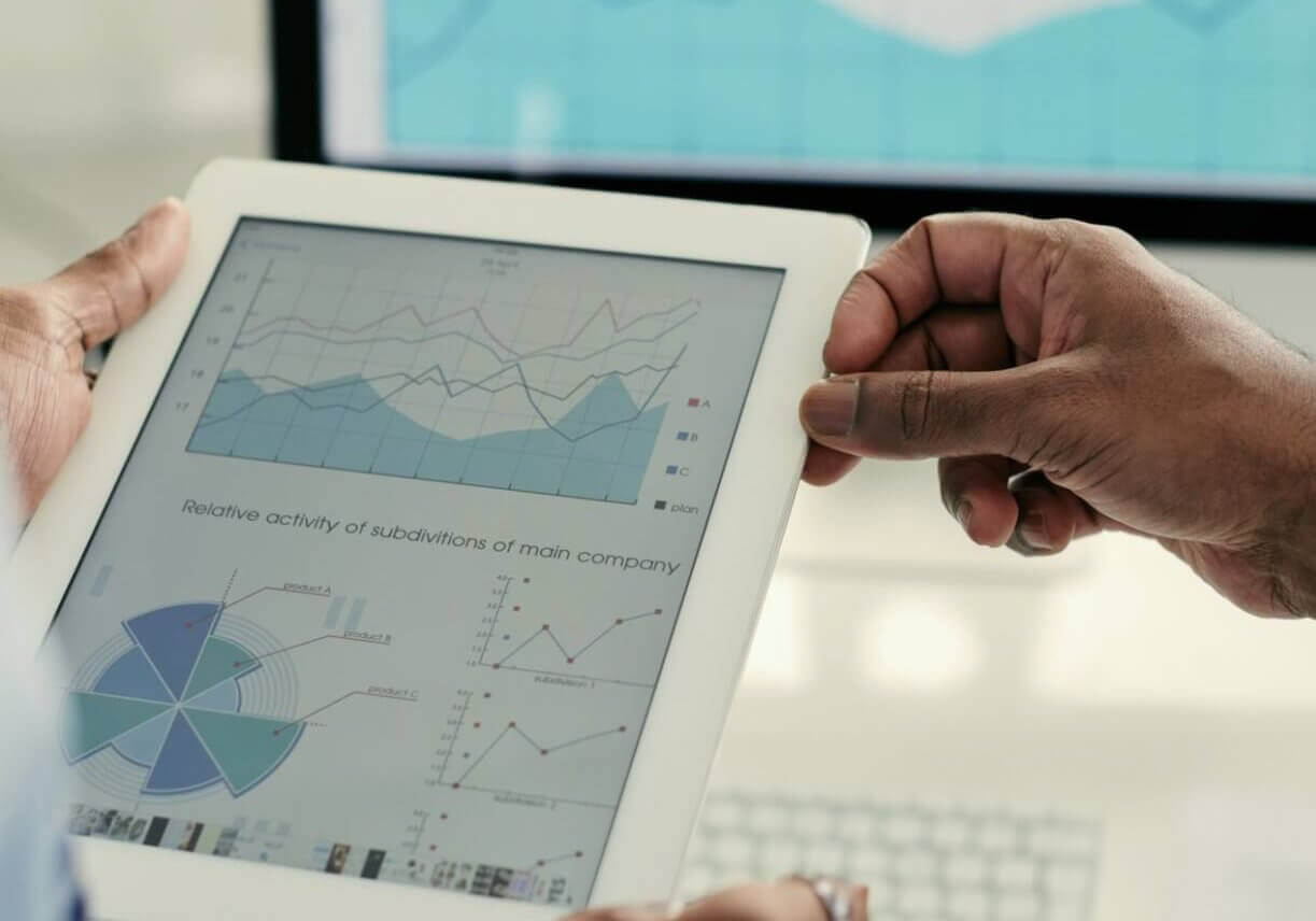 ways-to-give_Appreciated Securities Document with financial diagram on tablet computer in hands of business executives