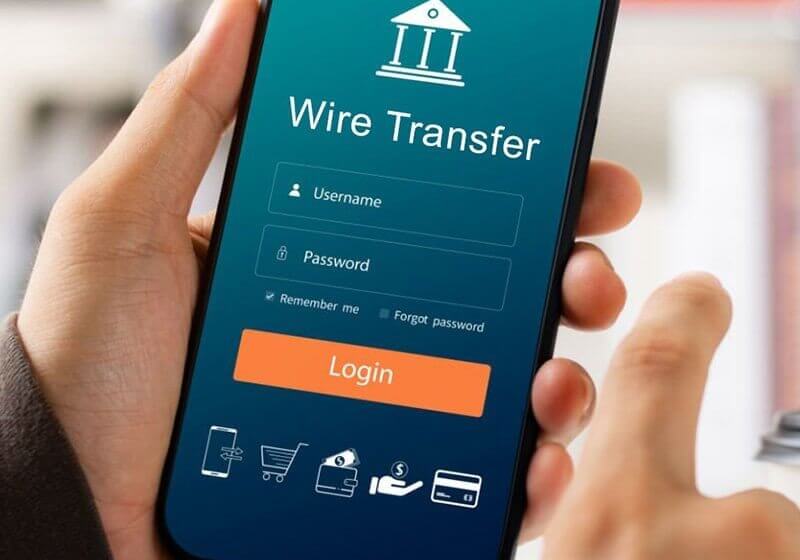 ways-to-give_Wire Transfer Male executive using smartphone to conduct online mobile banking, investing in stocks and mutual funds, retirement investment ideas.